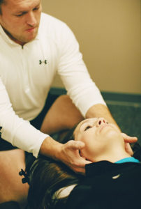 Dr Zack massaging a womans neck